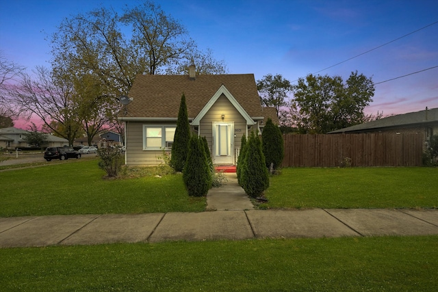 bungalow featuring a lawn