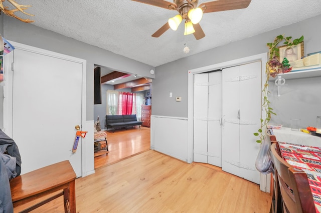 interior space with hardwood / wood-style floors, ceiling fan, and a textured ceiling