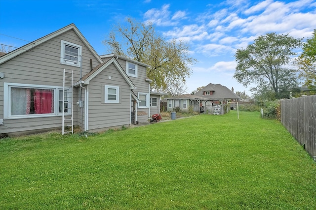 back of property featuring a lawn