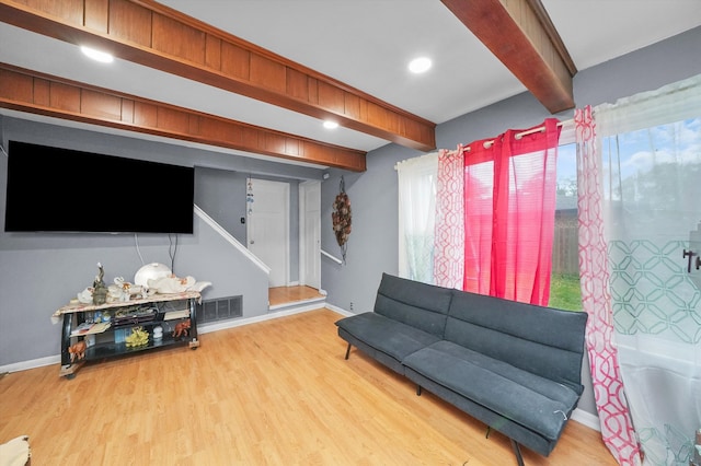 living room with hardwood / wood-style floors and beam ceiling