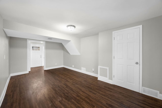 additional living space with dark hardwood / wood-style flooring