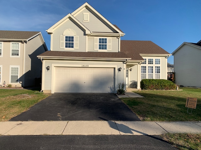 view of front of property with a garage and a front yard