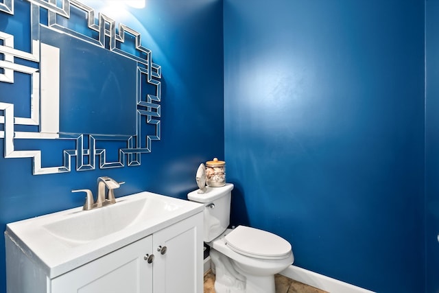 bathroom featuring tile patterned flooring, vanity, and toilet