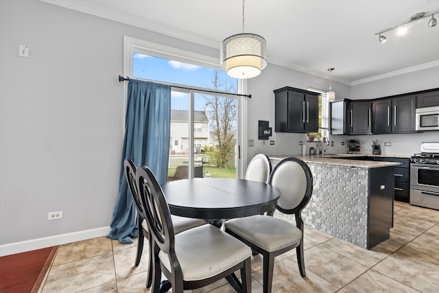 tiled dining room featuring crown molding and sink