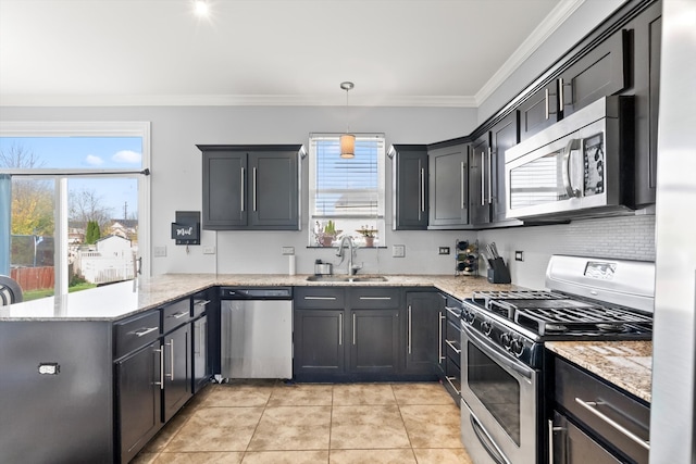 kitchen with kitchen peninsula, a wealth of natural light, sink, and stainless steel appliances