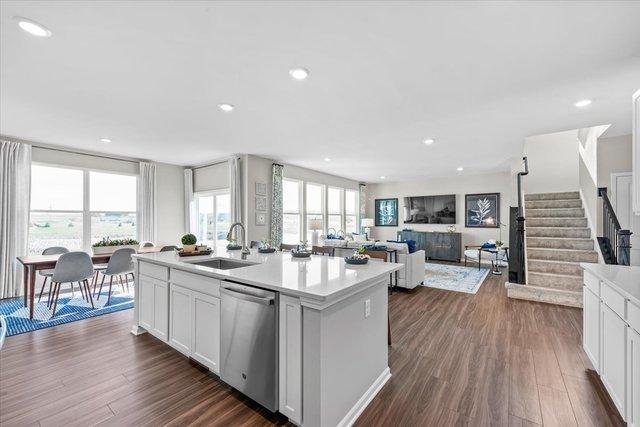 384 W Point Cir, Algonquin, IL 60102 - kitchen featuring stainless steel dishwasher, a sink, a center island with sink, dark wood-type flooring, and recessed lighting