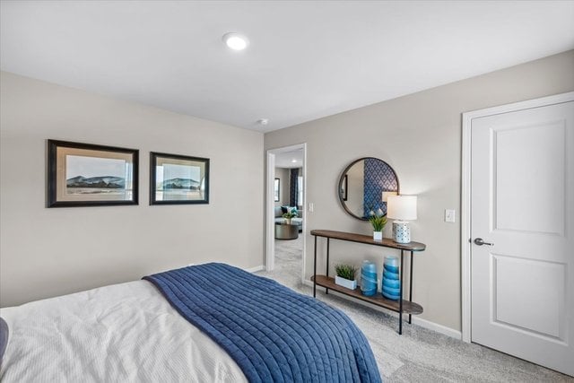 bedroom featuring light colored carpet