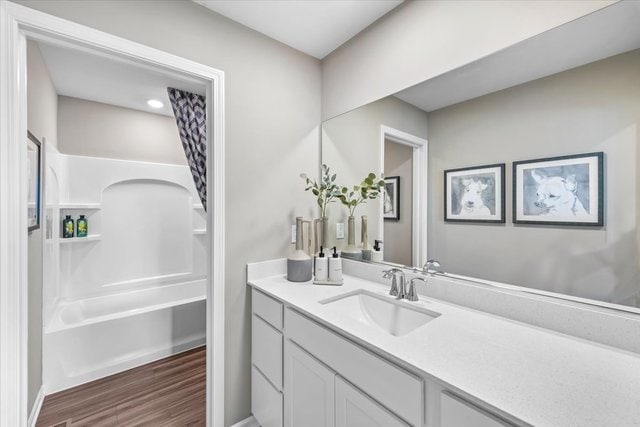 bathroom featuring vanity, separate shower and tub, and wood-type flooring