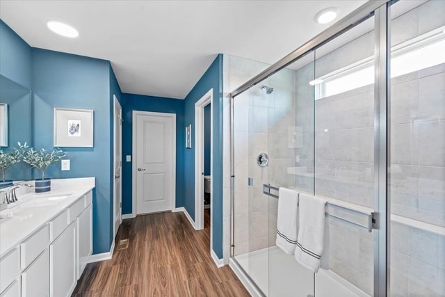 bathroom featuring vanity, hardwood / wood-style flooring, and an enclosed shower