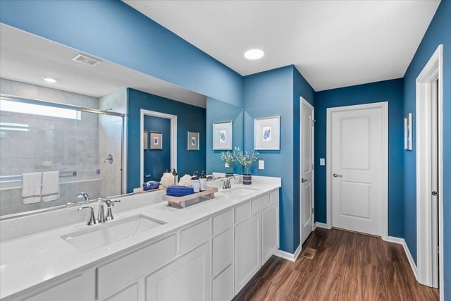 bathroom featuring vanity, hardwood / wood-style flooring, and an enclosed shower