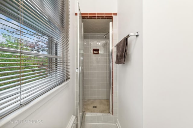 bathroom with a shower with door