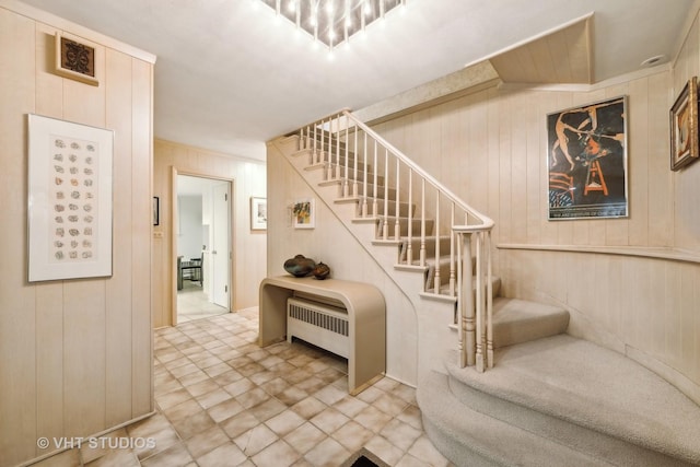 stairs with radiator heating unit and wooden walls