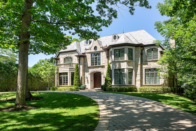 french country home with a front lawn