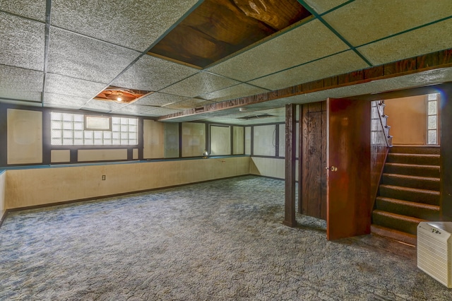 basement featuring a drop ceiling and carpet floors