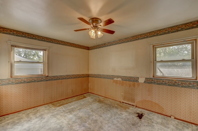 carpeted spare room with ceiling fan