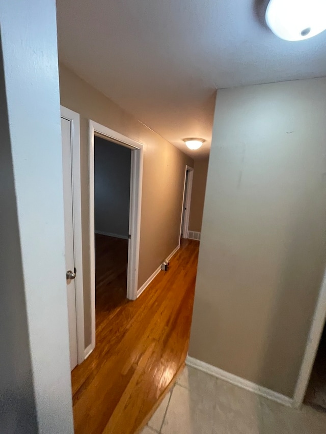 corridor with wood-type flooring