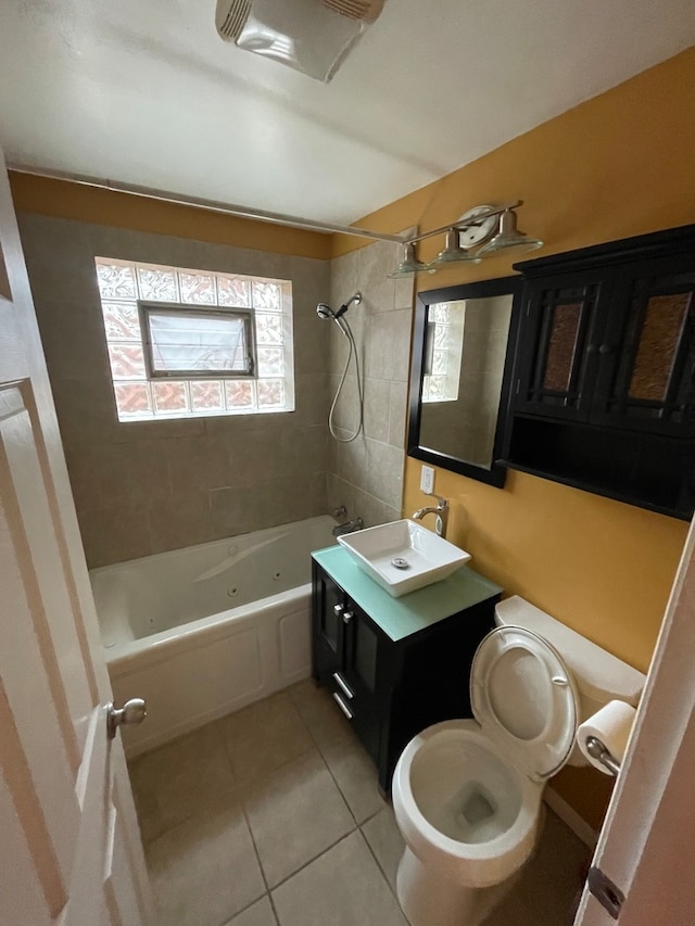 full bathroom featuring tiled shower / bath combo, vanity, tile patterned flooring, and a healthy amount of sunlight