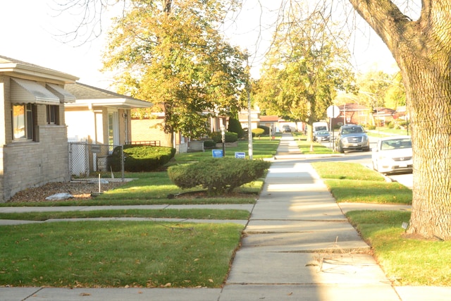 view of home's community with a lawn