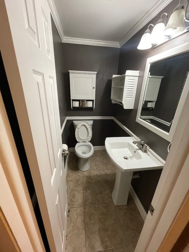 bathroom with ornamental molding, tile patterned flooring, and toilet