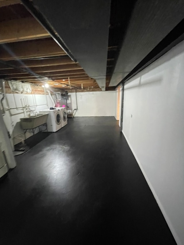 basement featuring separate washer and dryer and sink