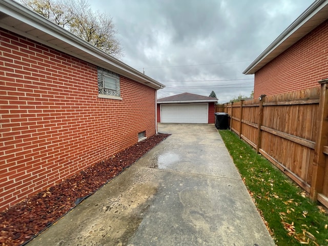 view of side of home with a garage and an outdoor structure