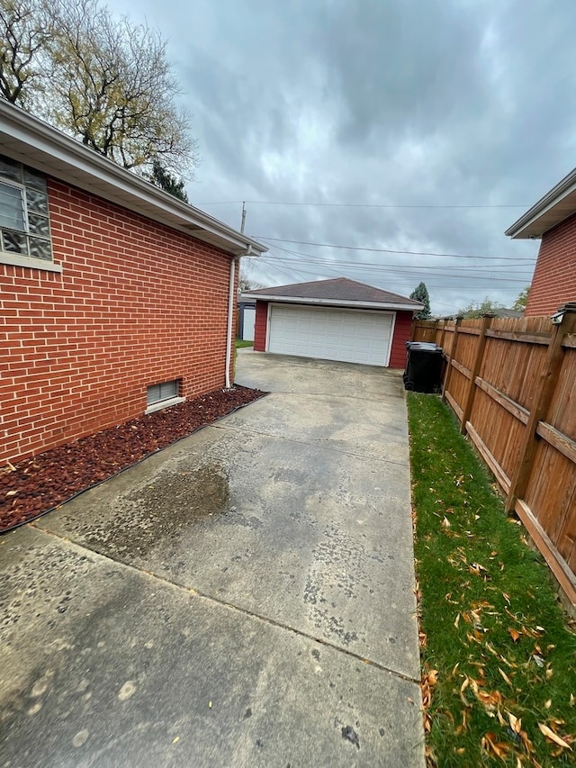 view of side of property with a garage and an outbuilding