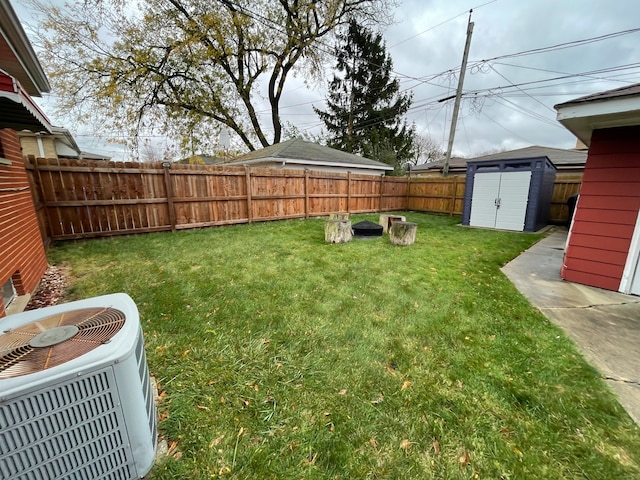 view of yard with a storage shed and central AC