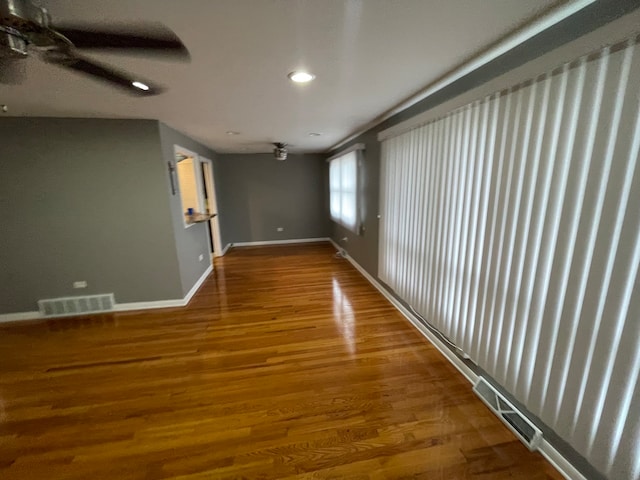 empty room with hardwood / wood-style flooring and ceiling fan