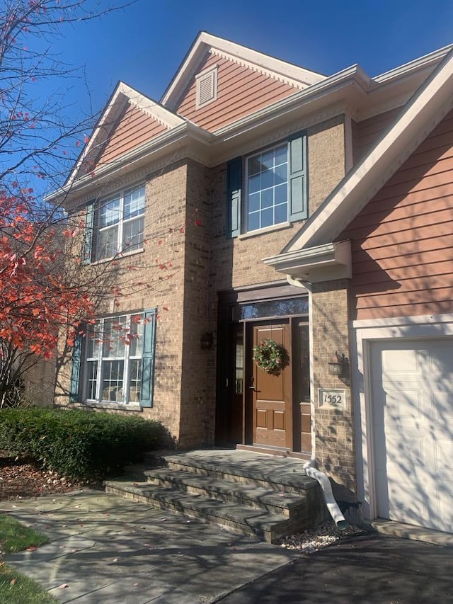 doorway to property with a garage