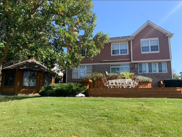 rear view of house featuring a lawn