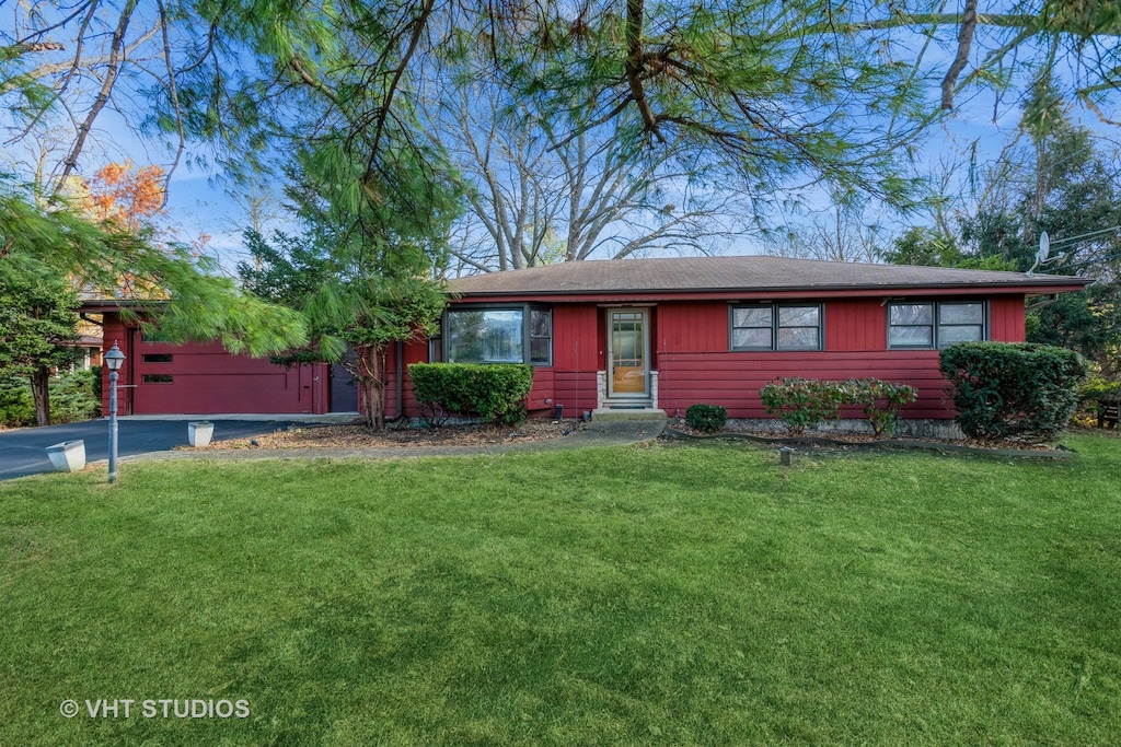 single story home with a front lawn and a garage