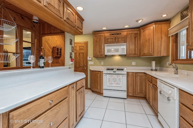 kitchen featuring sink, white appliances, and light tile patterned floors