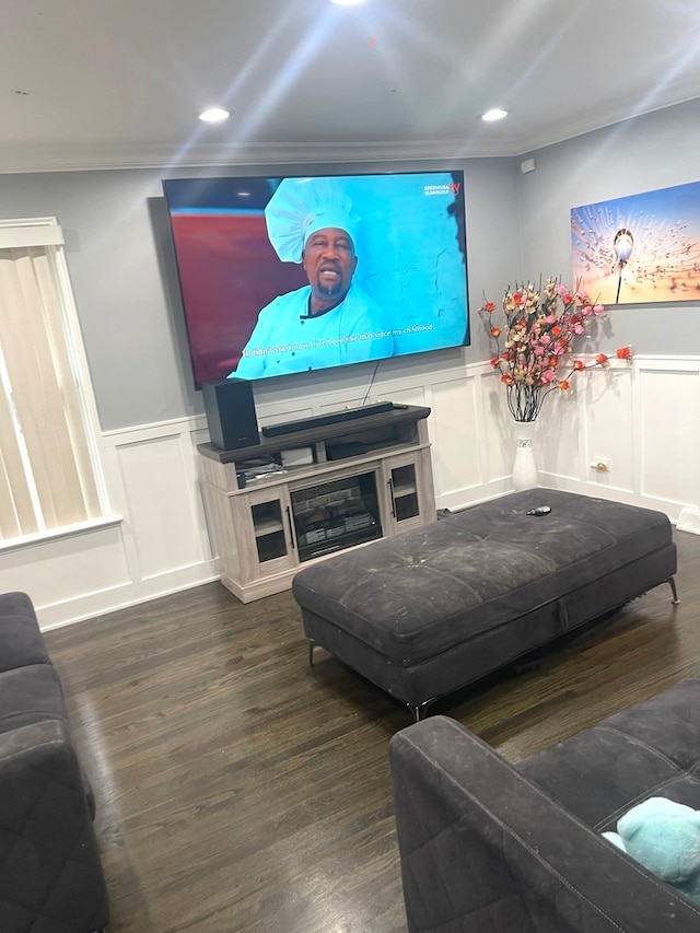 living room with dark wood-type flooring and ornamental molding