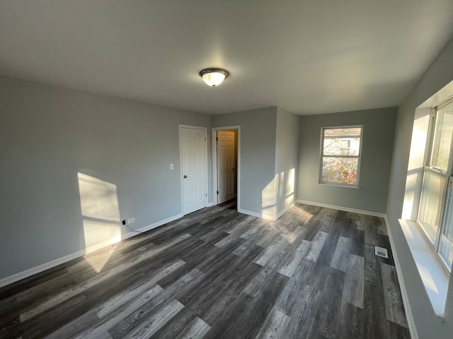 spare room with dark wood-type flooring