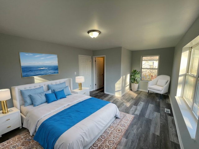 bedroom with dark hardwood / wood-style flooring