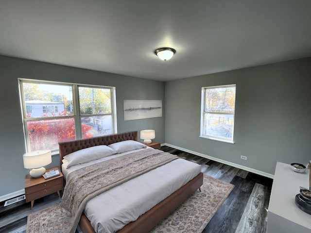 bedroom with dark wood-type flooring