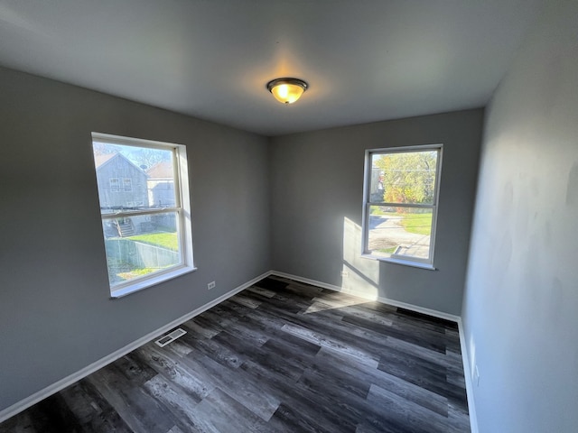 spare room with dark hardwood / wood-style floors