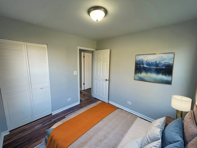 bedroom featuring dark hardwood / wood-style flooring and a closet