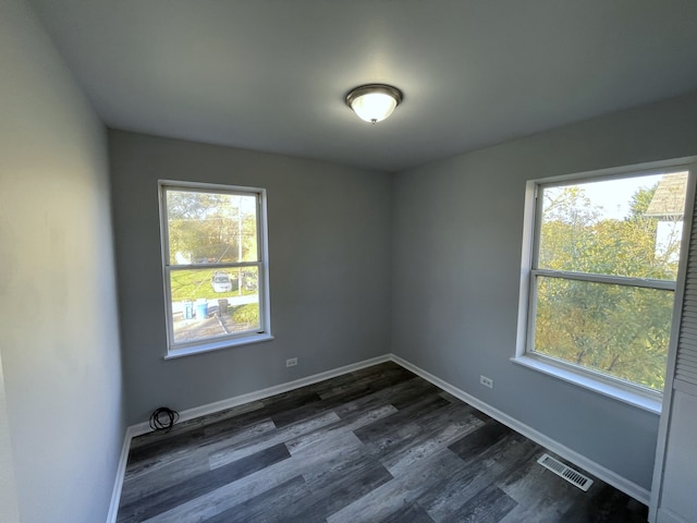 unfurnished room featuring dark hardwood / wood-style flooring