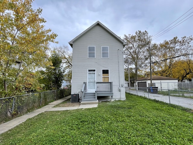 back of property featuring central air condition unit and a lawn