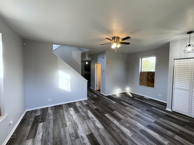 unfurnished living room with ceiling fan and dark hardwood / wood-style floors