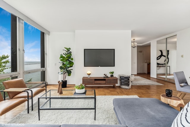 living room with an inviting chandelier and parquet floors