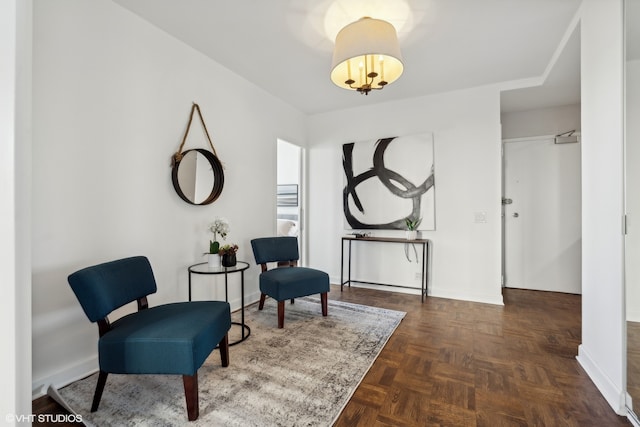 sitting room featuring dark parquet flooring