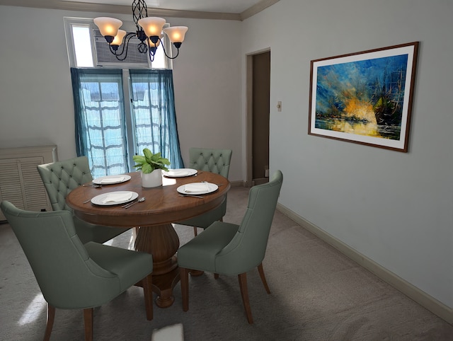 dining room featuring a chandelier, crown molding, and light colored carpet