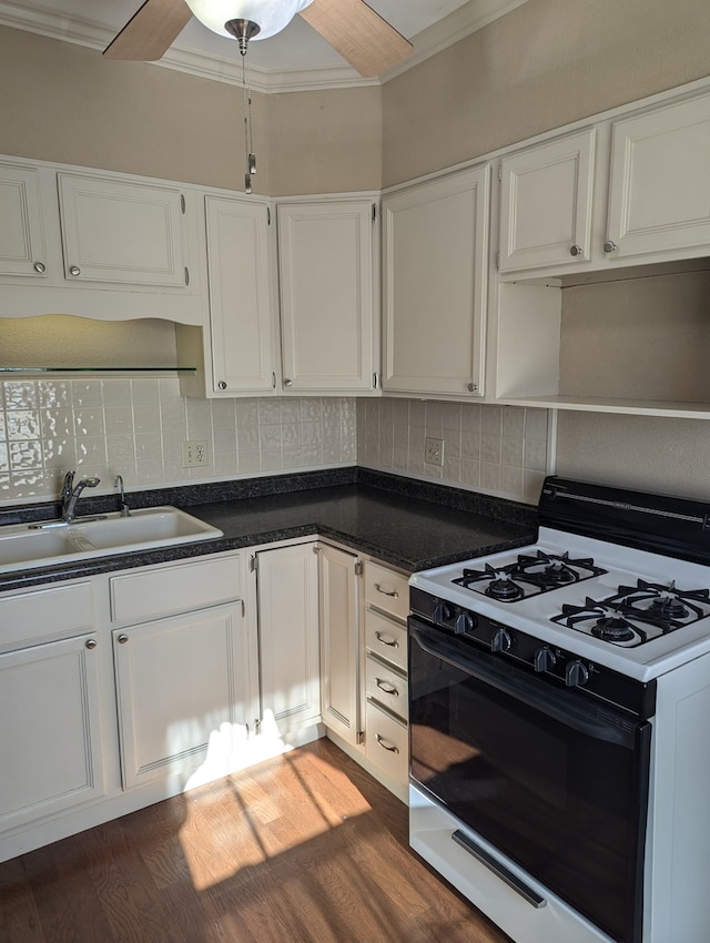 kitchen featuring ornamental molding, white cabinetry, dark hardwood / wood-style flooring, white range with gas stovetop, and decorative backsplash