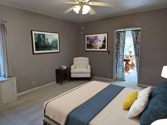 carpeted bedroom with ceiling fan and crown molding