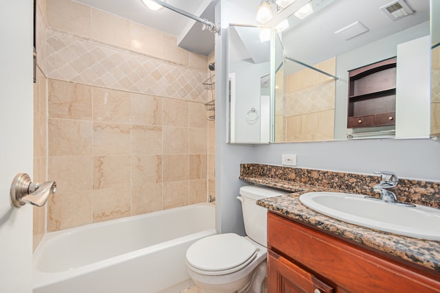 full bathroom with toilet, vanity, and tiled shower / bath