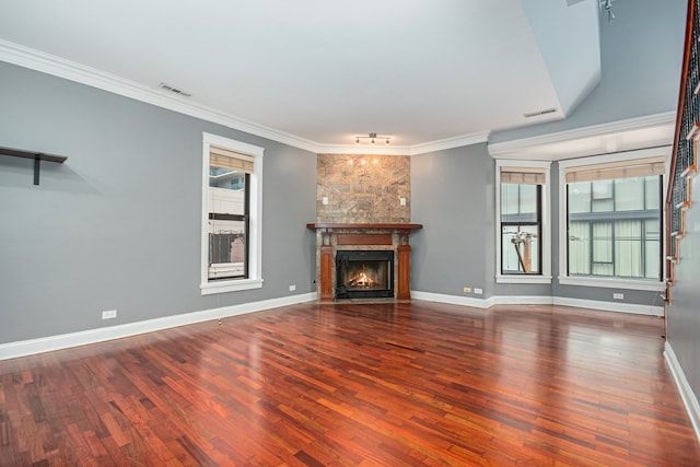 unfurnished living room featuring a fireplace, hardwood / wood-style flooring, and crown molding