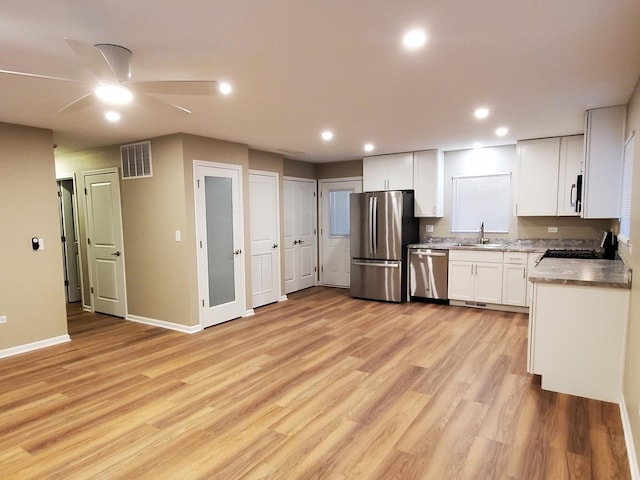 kitchen featuring sink, light hardwood / wood-style flooring, ceiling fan, white cabinetry, and stainless steel appliances