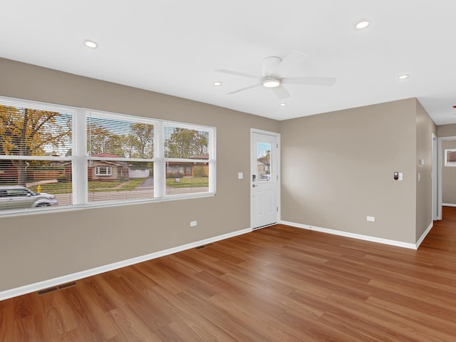 unfurnished room with hardwood / wood-style flooring and ceiling fan